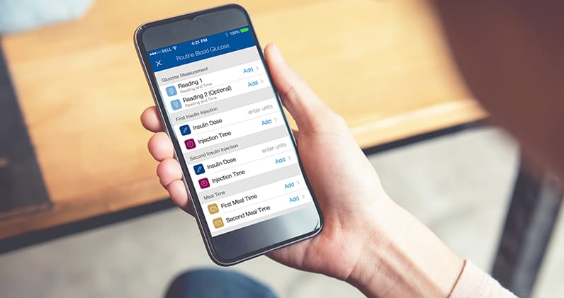 Woman using diabetes tracker app on her phone.